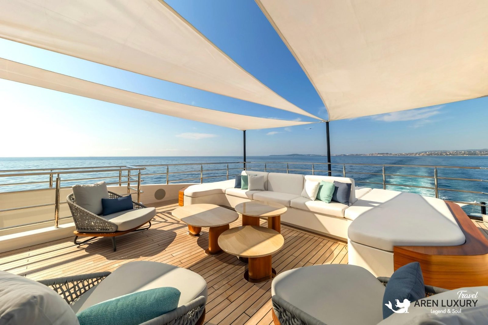 Spacious upper deck lounge on the Eternal Spark yacht featuring white sectional sofas and modern triangular sunshades against a clear blue sky.