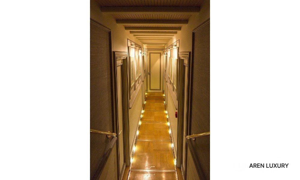 Cobra King luxury gulet illuminated cabin hallway leading to private guest rooms