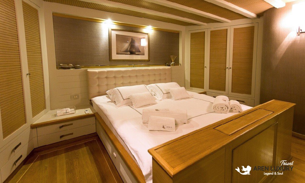 Cobra King luxury gulet master bedroom with premium linens and wooden interior
