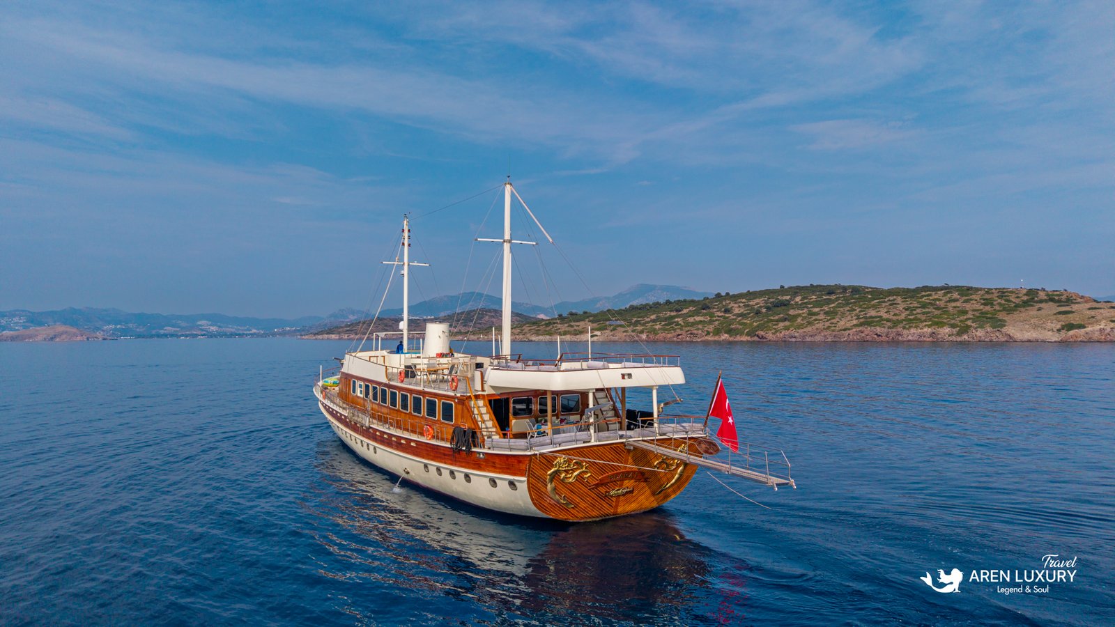 elara-1-gulet-stern-view Close-up rear view of the Elara 1 gulet yacht showing the polished wooden hull and Turkish flag.