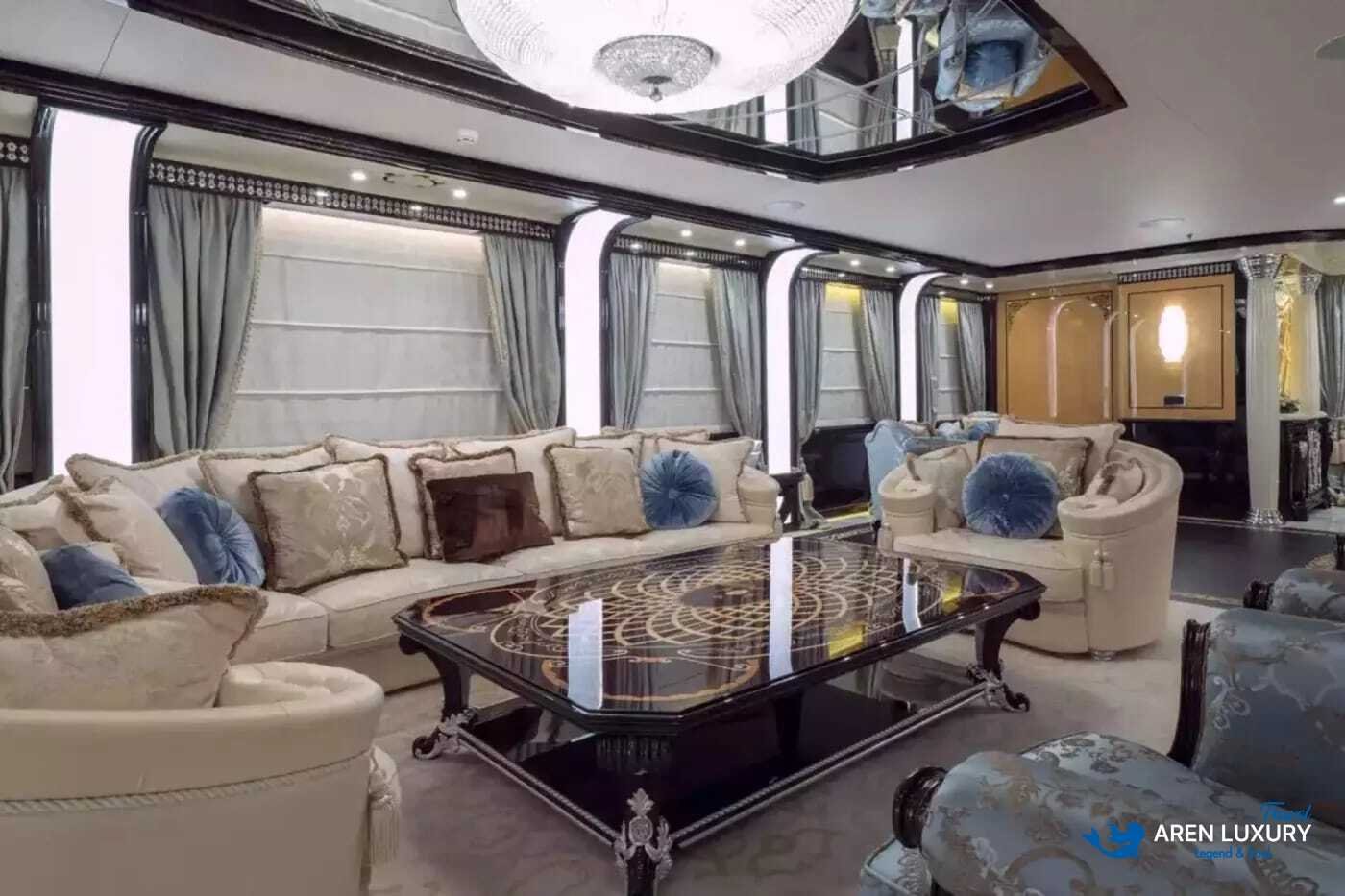 Main saloon of Elements luxury yacht with gold-leaf detailing and backlit onyx wall panels.