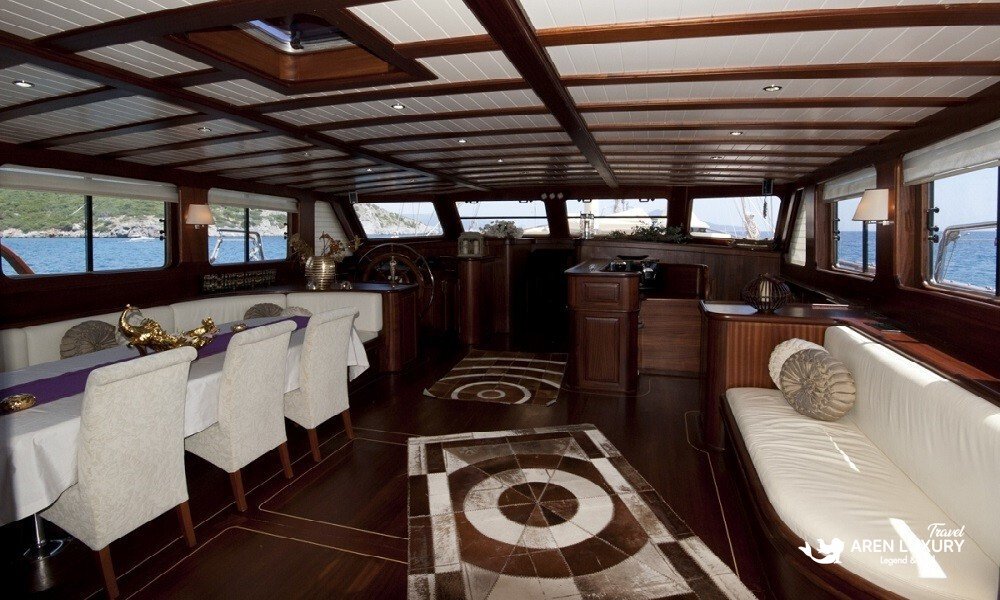 Arif Kaptan A gulet charter Turkey interior salon with dining area and panoramic sea views