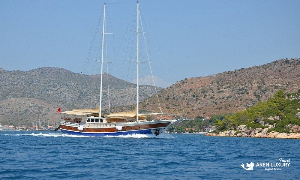 The luxury Gulet C Taner 2 sailing on the turquoise waters of the Turkish coast near Bodrum.