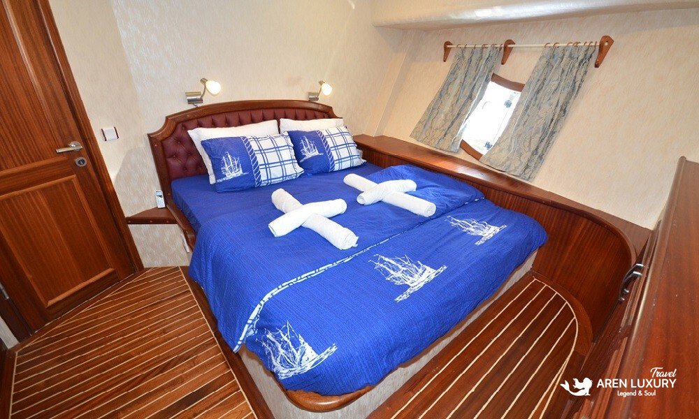 Gulet C Taner 2 Charter Turkey Double Cabin A luxury double en-suite cabin on the Gulet C Taner 2 Charter Turkey featuring nautical-themed bedding.