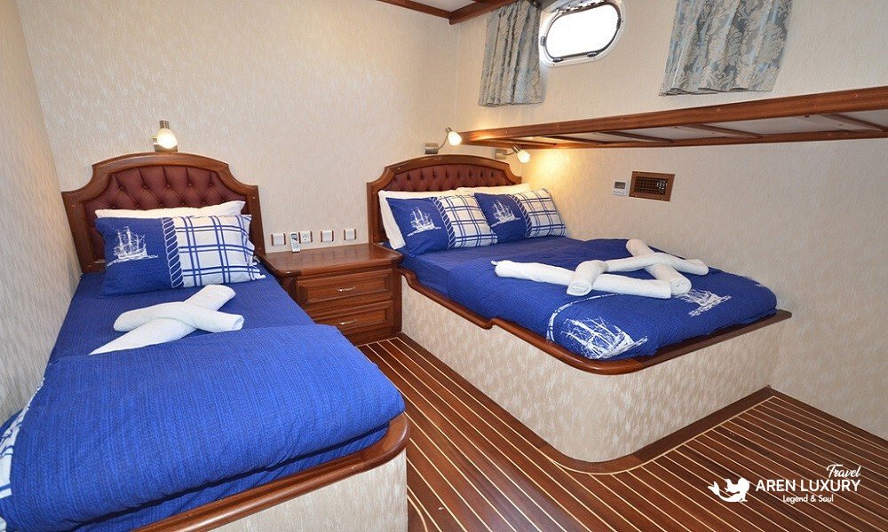 gulet-c-taner-2-turkey-charter A spacious triple cabin with high-quality wooden interior on a Gulet C Taner 2 Charter Turkey.