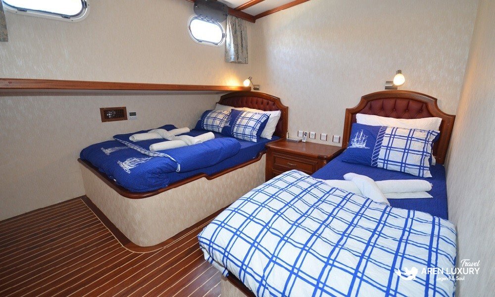 gulet-c-taner-2-turkey-charter A spacious twin cabin with separate double and single beds on a Gulet C Taner 2 Charter Turkey.