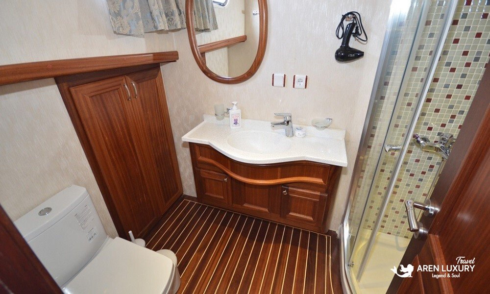 gulet-c-taner-2-turkey-charter Modern en-suite bathroom with glass shower and mahogany finishes on a Gulet C Taner 2 Charter Turkey.
