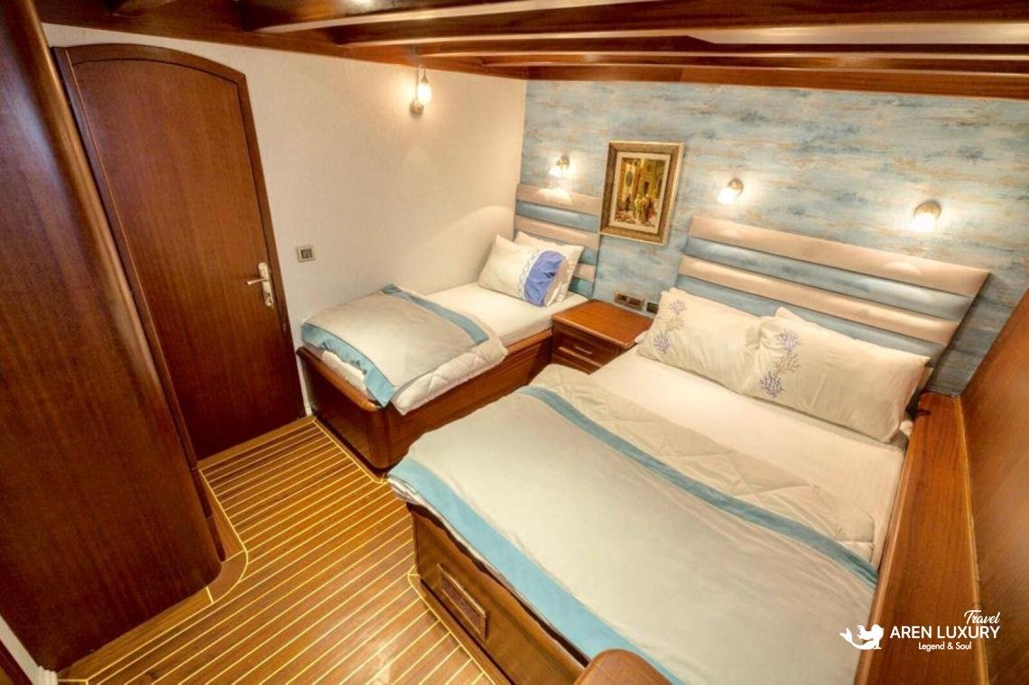 gulet-freedom-luxury-twin-cabin-interior Modern twin cabin on Gulet Freedom with high-quality linens, polished wood floors, and soft warm lighting.