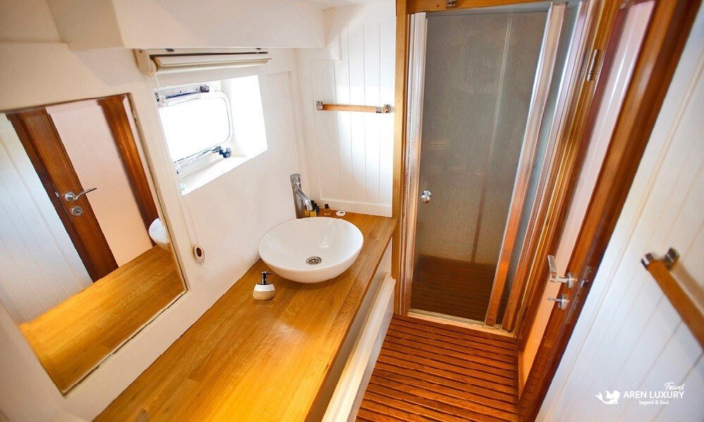 weekly-gulet-charter-maske-2-ensuite-bathroom-shower Weekly gulet charter Maske 2 master suite ensuite bathroom with glass shower cabin and wooden vanity
