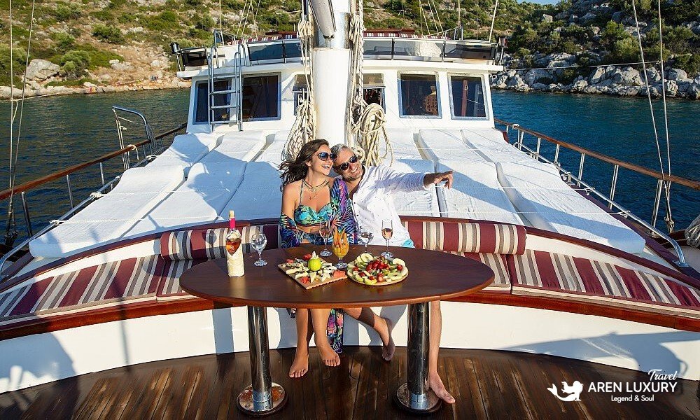 Guests enjoying a gourmet fruit platter on the deck of Gulet Vesta 1 Sevil during a private charter in Turkey