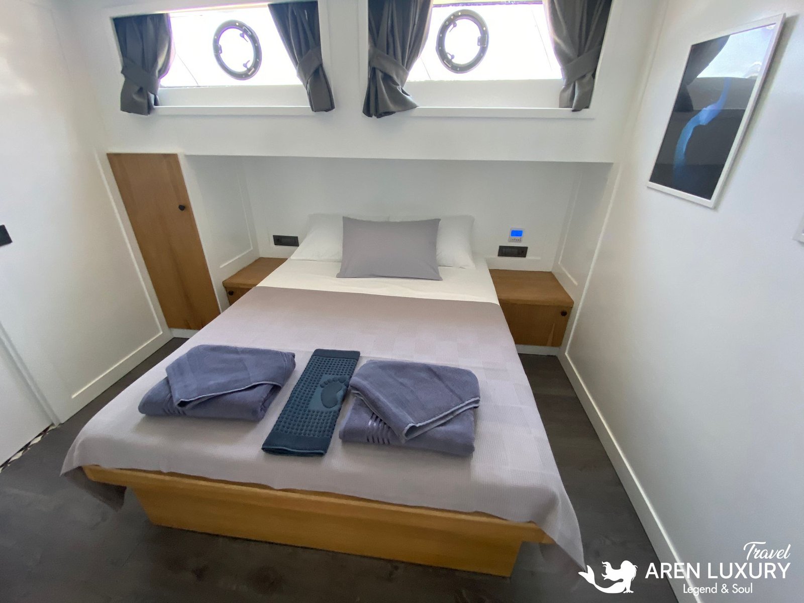 Gulet Albatros M Luxury Guest Cabin Interior Spacious double guest cabin on Gulet Albatros M with twin porthole windows, modern minimalist furniture, and soft lighting.