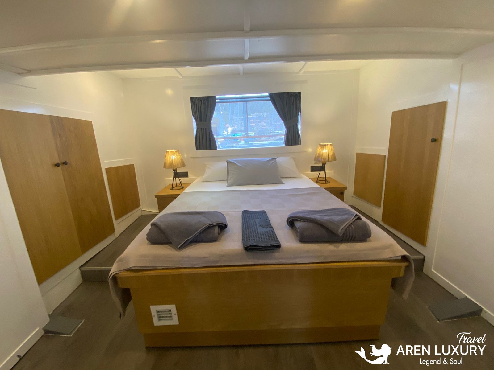 Gulet Albatros M Master Suite Interior Luxurious master cabin on Gulet Albatros M with a large double bed, natural wood accents, and elegant bedside lamps.