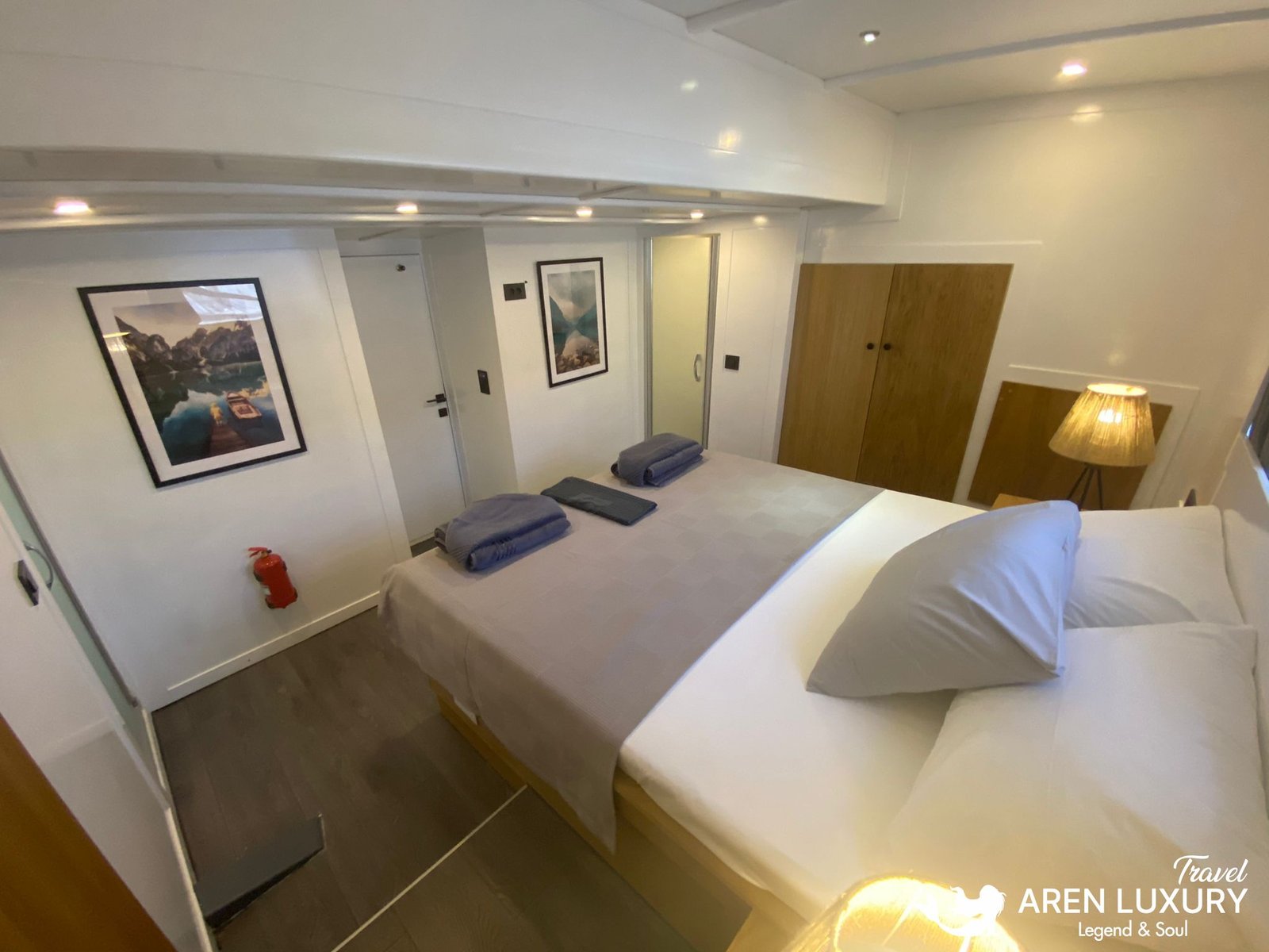 Gulet Charter Albatros M Comfortable Guest Suite Spacious guest cabin on Gulet Albatros M featuring a large double bed, modern artwork, and warm ambient lighting.